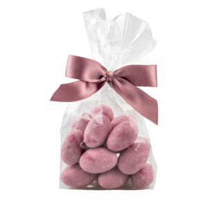 Migdał w białej czekoladzie barwiony na różowo w foliowym opakowaniu z kokardą